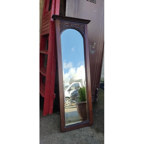 12 - An antique mirror with bevelled glass & carved frame. 39x101cm