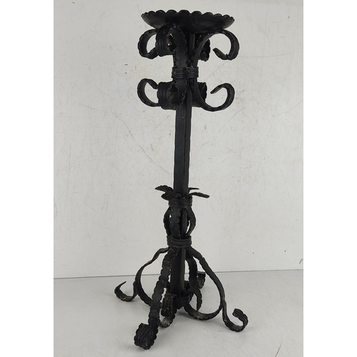 22 - A large decorative wrought iron candlestick. 51cm tall.