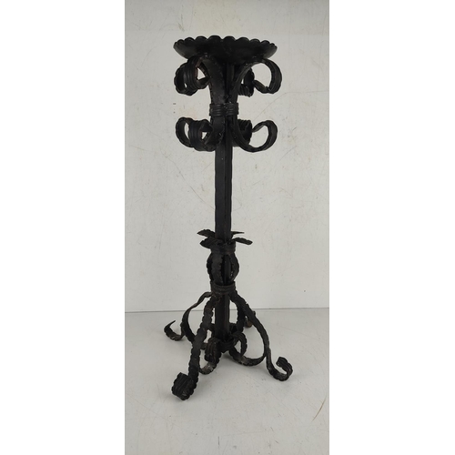 22 - A large decorative wrought iron candlestick. 51cm tall.