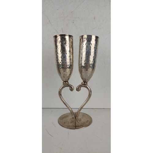 26 - A pair of silver plated champagne flutes, produced by Culinary Concepts - London.