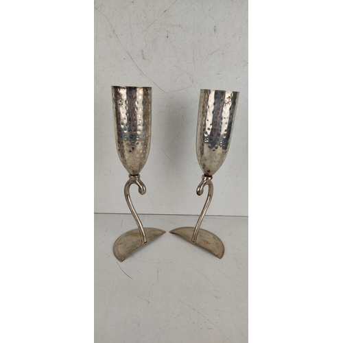 26 - A pair of silver plated champagne flutes, produced by Culinary Concepts - London.