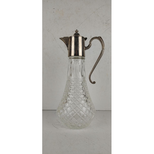 28 - A vintage claret jug with silver plated top.