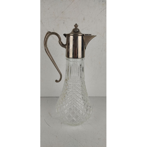 28 - A vintage claret jug with silver plated top.