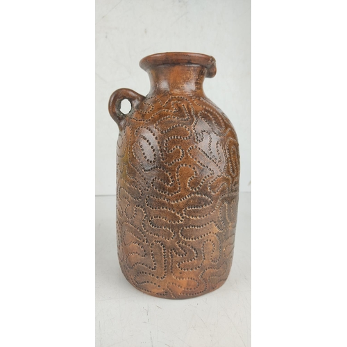 29 - An antique salt glaze jug with nail punch decorative design.