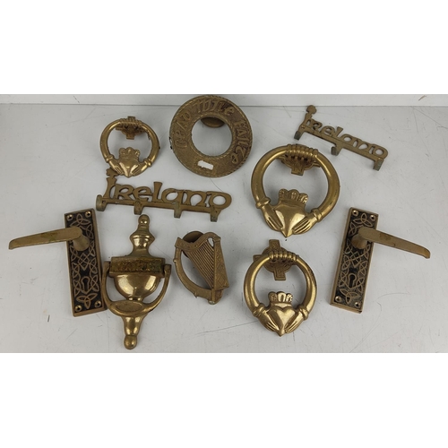 39 - An assortment of Irish themed brass hardware.