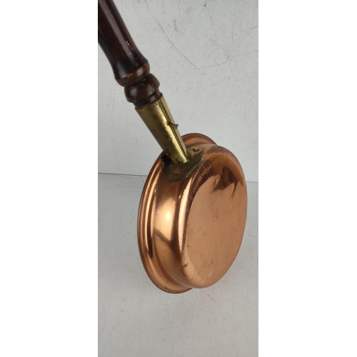 46 - A vintage copper bed pan with mahogany turned handle.