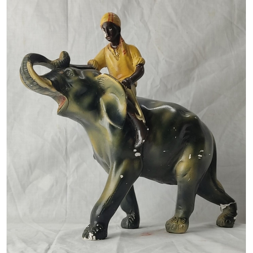 71 - A vintage clay pottery ornament of an elephant and mahout (a/f). 30cm tall.