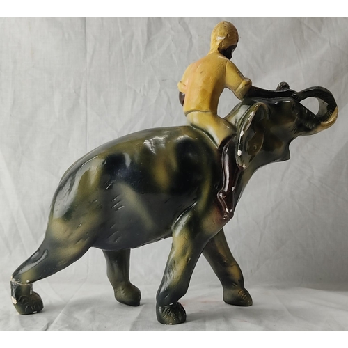 71 - A vintage clay pottery ornament of an elephant and mahout (a/f). 30cm tall.