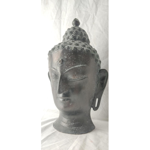 77 - A stunning metal Buddha head. 37cm tall