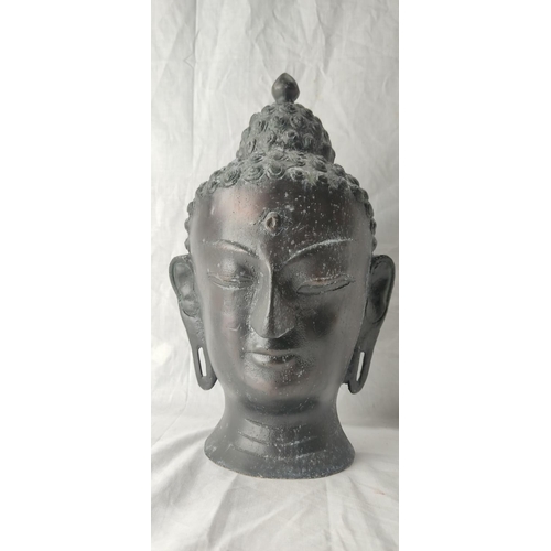 77 - A stunning metal Buddha head. 37cm tall