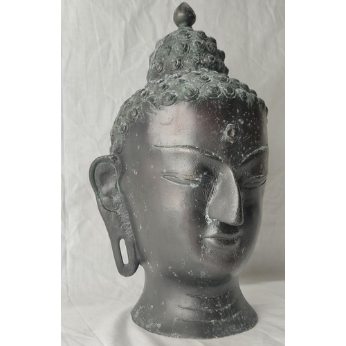 77 - A stunning metal Buddha head. 37cm tall