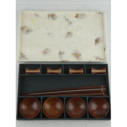 102 - A boxed set of wooden dipping bowls and chopstick set.