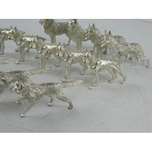 103 - A collection of metal dog figures.