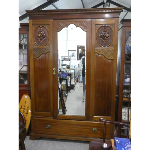188 - A stunning antique mahogany wardrobe with carved panels and mirror.