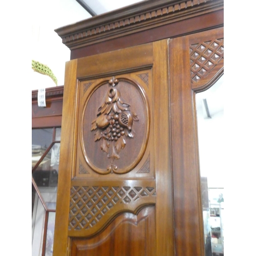 188 - A stunning antique mahogany wardrobe with carved panels and mirror.