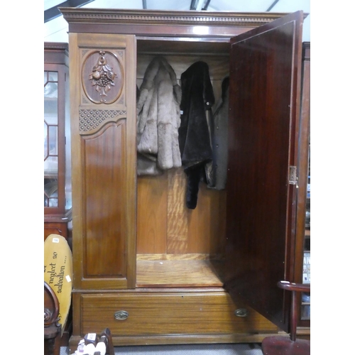 188 - A stunning antique mahogany wardrobe with carved panels and mirror.