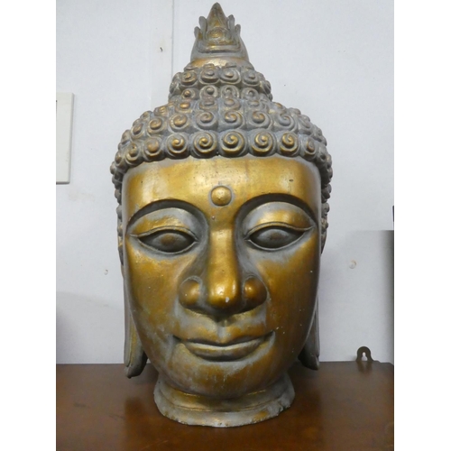 218 - A large ceramic Buddha head, measuring 25.5inches.
