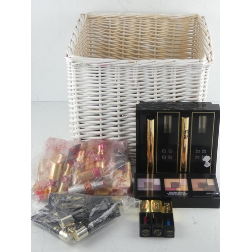 455 - A wicker basket and a large lot of Yves Saint Laurent makeup.