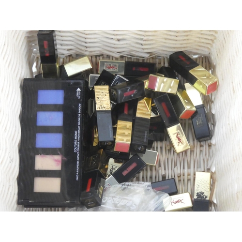 455 - A wicker basket and a large lot of Yves Saint Laurent makeup.