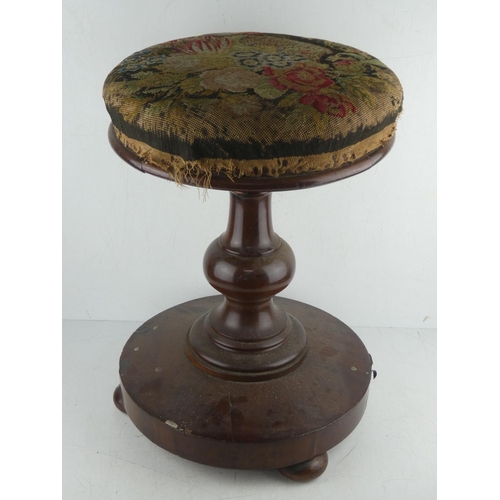 458 - An antique mahogany piano stool with tapestry topped rotating seat.