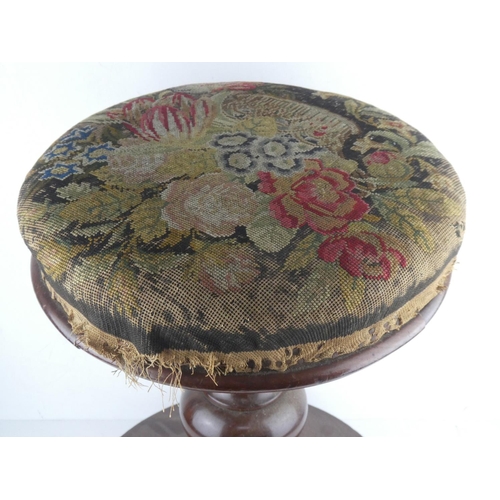 458 - An antique mahogany piano stool with tapestry topped rotating seat.