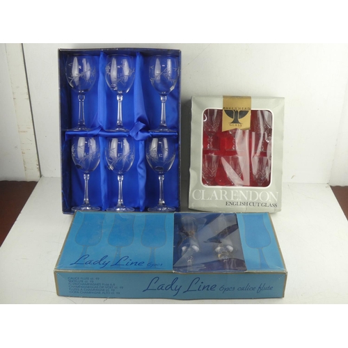 463 - A boxed set of six Irish Duiske crystal wine glasses and two other boxed sets of glasses.