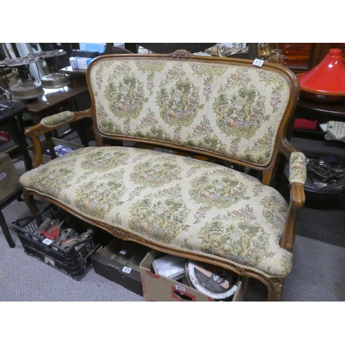 472 - An oak framed two seater sofa with tapestry style upholstery.