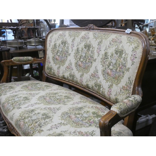 472 - An oak framed two seater sofa with tapestry style upholstery.