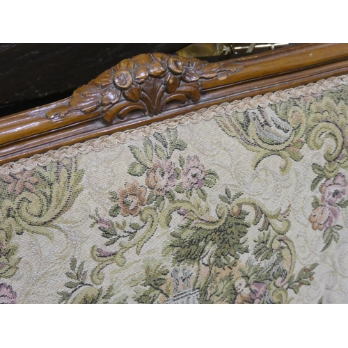 472 - An oak framed two seater sofa with tapestry style upholstery.