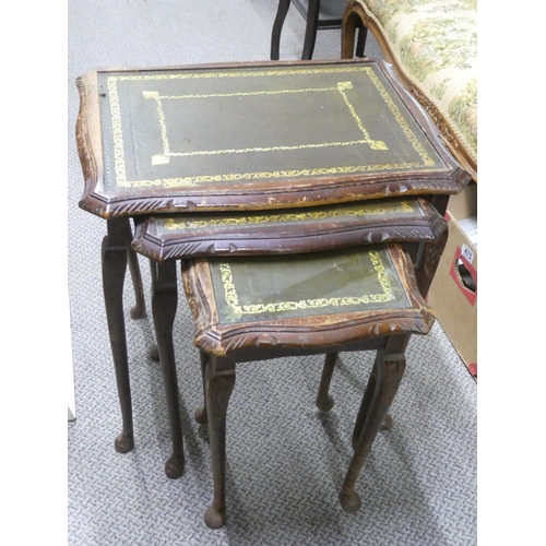 497 - A nest of three leather topped tables.