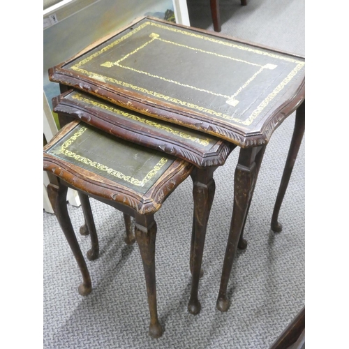 497 - A nest of three leather topped tables.