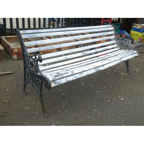 509 - A summer seat/ bench with decorative cast iron ends.