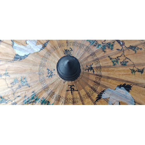209 - A decorative hand painted Oriental parasol.