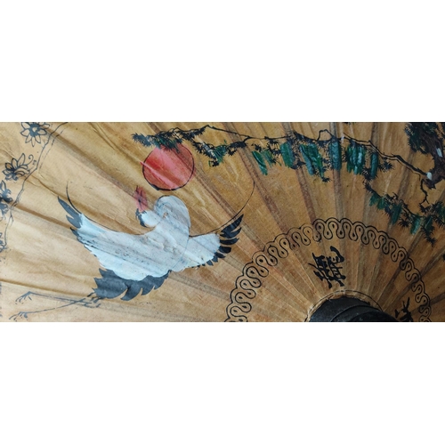 209 - A decorative hand painted Oriental parasol.