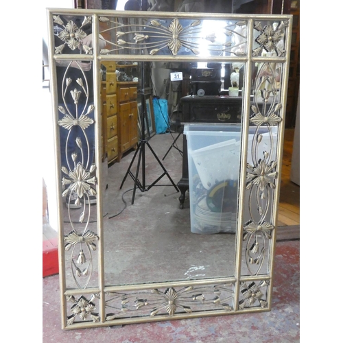 31 - A large stunning decorative metal framed wall mirror, 110cm x 80cm.