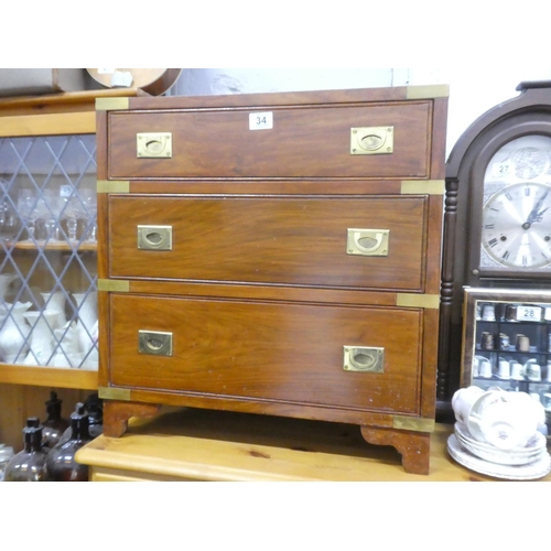34 - A stunning chest of three drawers with brass detail, 59cm x 60cm x 38cm.