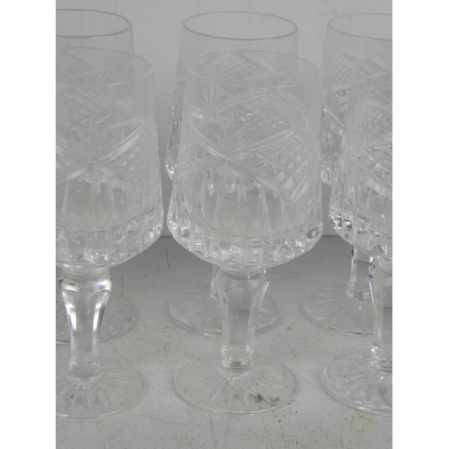 45 - A set of 12 cut glass sherry glasses.