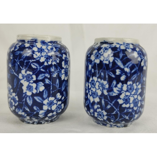 109 - A pair of antique miniature blue and white patterned vases.