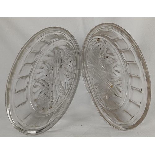 111 - A pair of antique glass jelly moulds.