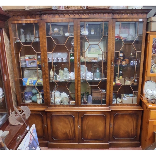 114 - A stunning large four door display cabinet with decorative moulded edging and astral glazed doors.