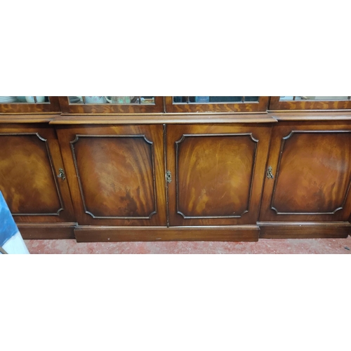 114 - A stunning large four door display cabinet with decorative moulded edging and astral glazed doors.