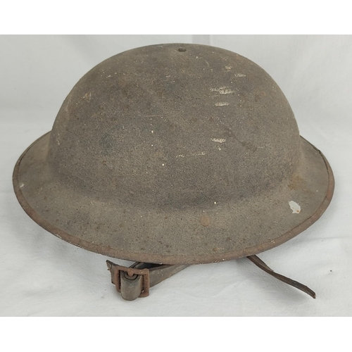 143 - An antique WW1 British military helmet with original liner.