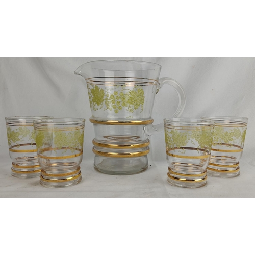 177 - A vintage glass water jug and four glasses.