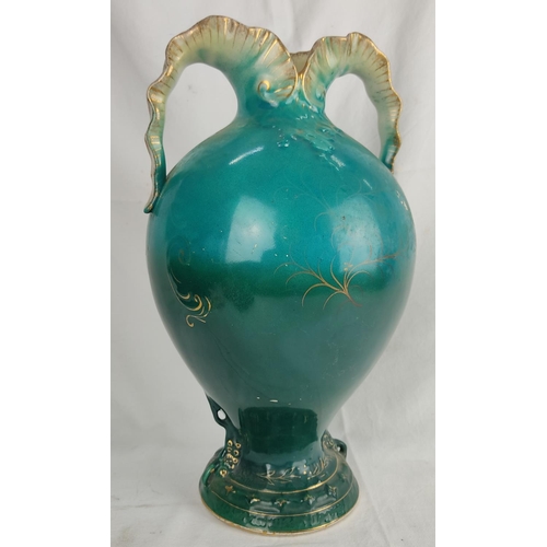 195 - An antique twin handled vase with floral detail, 34cm.