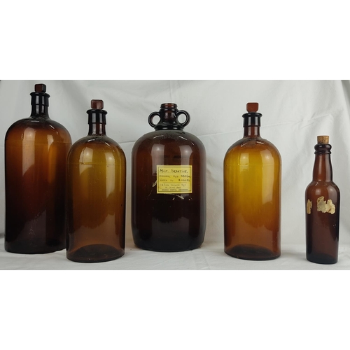 51 - Three large vintage coloured glass chemist bottles with original glass stoppers and two others.