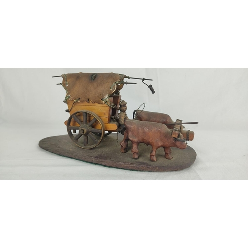 73 - A vintage hand carved wooden sculpture of Oxen and cart.