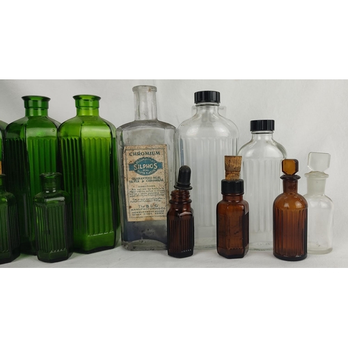 95 - A large collection of antique glass chemist bottles.