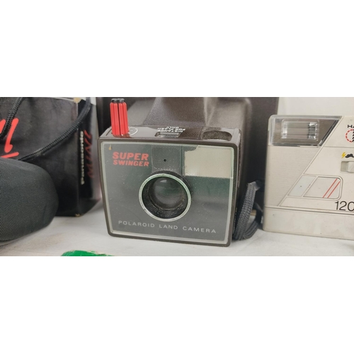 97 - A vintage Polaroid land 'Super Swinger' camera and case and lots more.