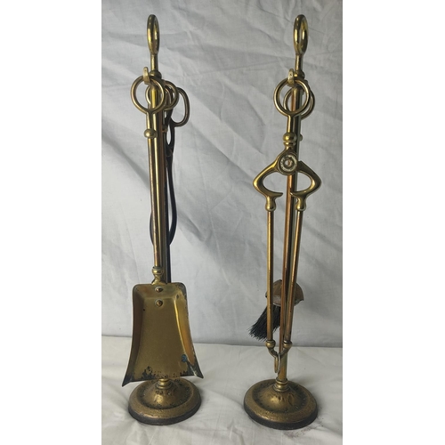 216 - A pair of vintage brass companion sets.