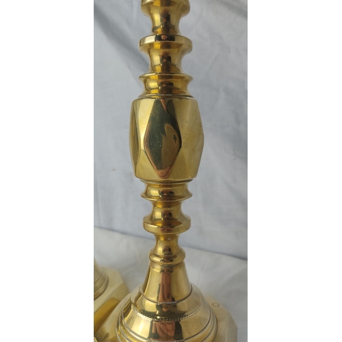 220 - A pair of antique brass 'King of Diamond' pattern candlesticks, English made, 30cm.